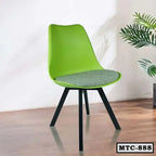Modern green metal tulip chair with gray cushion, black legs, on wooden floor near plant