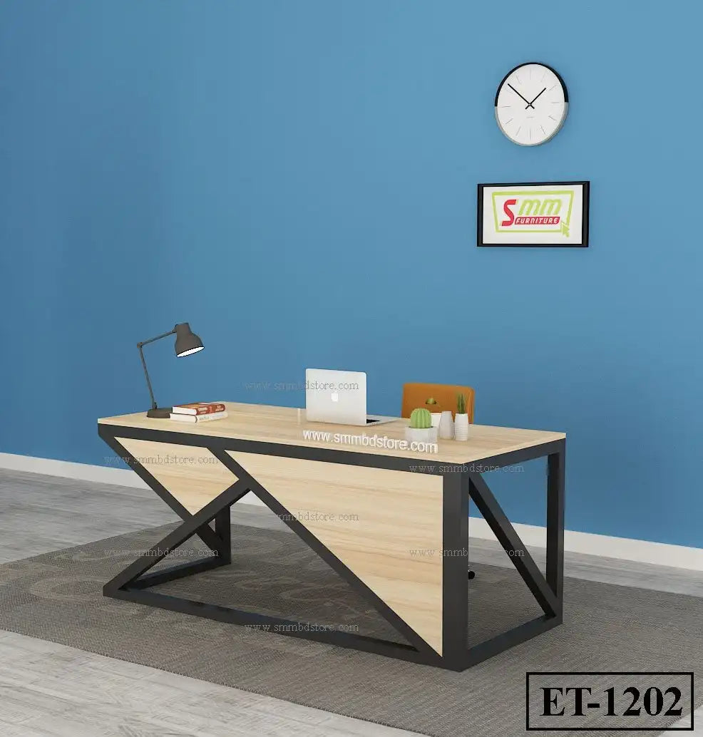 Modern office desk with geometric black metal frame, wood top, laptop, lamp, and decor in blue room