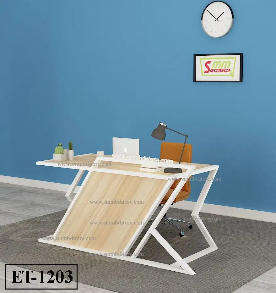 Modern office desk with light wood finish, white frame, laptop, lamp, and orange chair in a blue room
