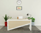 Modern office desk with laptop, lamp, books, and indoor plants in a minimalist workspace