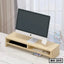 Wooden monitor stand with storage compartments holding an iMac on a modern desk