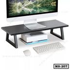 Modern black wooden monitor stand for desk organization with computer, books, keyboard, and mouse