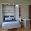 Modern Murphy wall bed with built-in shelves, study desk, and blue bedding in a bedroom.