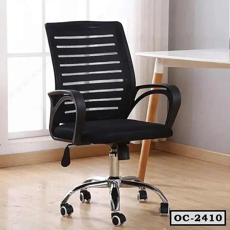 Black ergonomic mesh office chair with armrests and wheels beside a white desk
