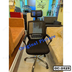 Black ergonomic office chair with mesh backrest, headrest, and chrome base in showroom