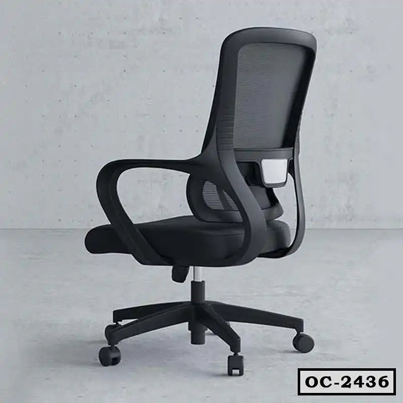 Black ergonomic mesh office chair with armrests and wheels on a grey floor