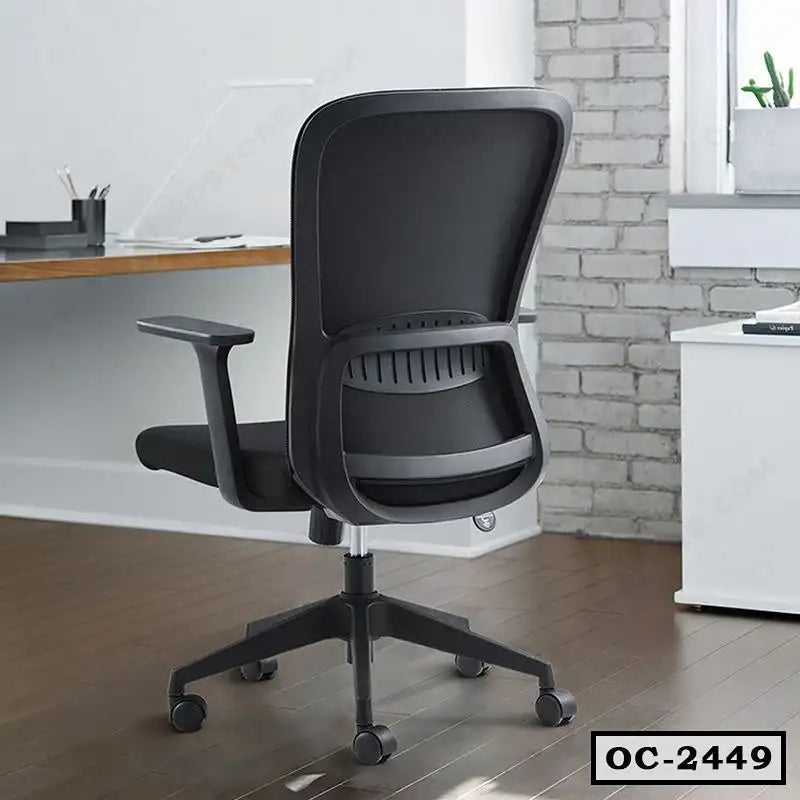 Modern ergonomic black office chair with mesh backrest on wheels in a home office setting