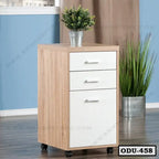 Modern wooden office drawer unit with three white drawers and caster wheels in a room setting