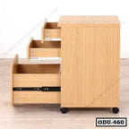 Light oak office drawer unit with three open drawers and wheels on a wood floor