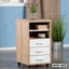 Wooden office drawer unit with three white drawers, open shelf, and caster wheels