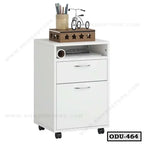 White office drawer unit on wheels with two drawers, open shelf, and decor on top