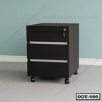 Modern black office drawer unit with three drawers, lock, and wheels on tiled floor