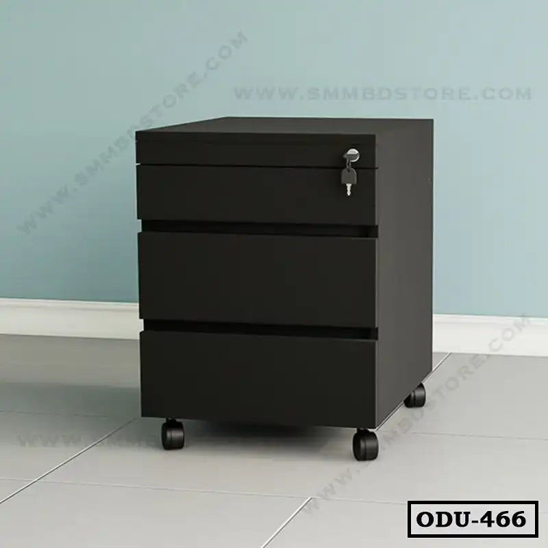 Black office drawer unit with three drawers and a lock, on wheels, against a blue wall