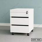 Modern white office drawer unit with three drawers and lock, on wheels, against a blue wall