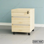 Light wood office drawer unit with lock and wheels on tiled floor against blue wall