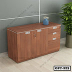 Modern wooden office file cabinet with drawers and doors, placed in a workspace setting.