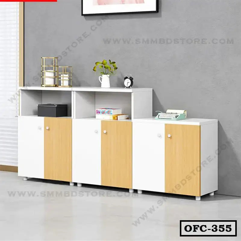 Modern white and wood office file cabinet with three doors and open shelves, placed against a gray wall.