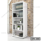 White office file cabinet with shelves, books, files, and plants against a brick wall