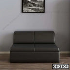 Modern dark grey office sofa with straight lines in a minimalist room, wood floor, wall art above sofa.