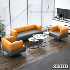 Modern office sofa set with orange and gray upholstery, round coffee tables, in a bright office lounge