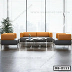 Modern office sofa set with gray and orange upholstery, glass tables, and city view window