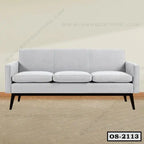 Modern three-seater office sofa with light grey upholstery and wooden legs on parquet floor