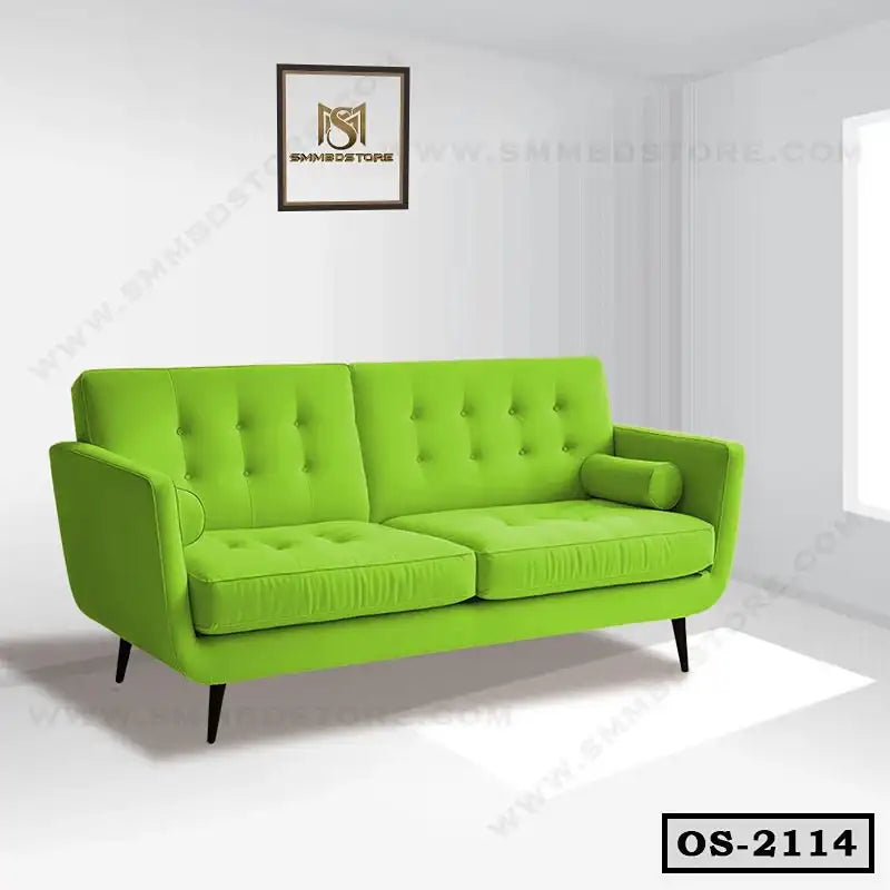 Modern green office sofa with tufted cushions and slim legs in a bright room