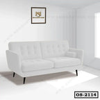 Modern white office sofa with tufted cushions and black legs in a bright room
