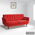 Modern red office sofa with button tufting and cylindrical cushions in a bright room