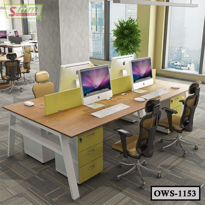 Modern office workstation with computers, ergonomic chairs, and city view windows