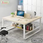 Modern office workstation with light wood desk, storage shelf, computers, and ergonomic chair