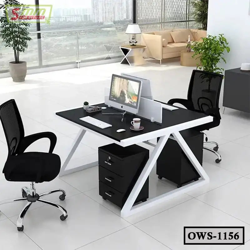 Modern office workstation with dual black mesh chairs, computer monitors, drawers, and city view