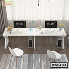 Modern white office workstation desk with dual computers, two chairs, and accessories