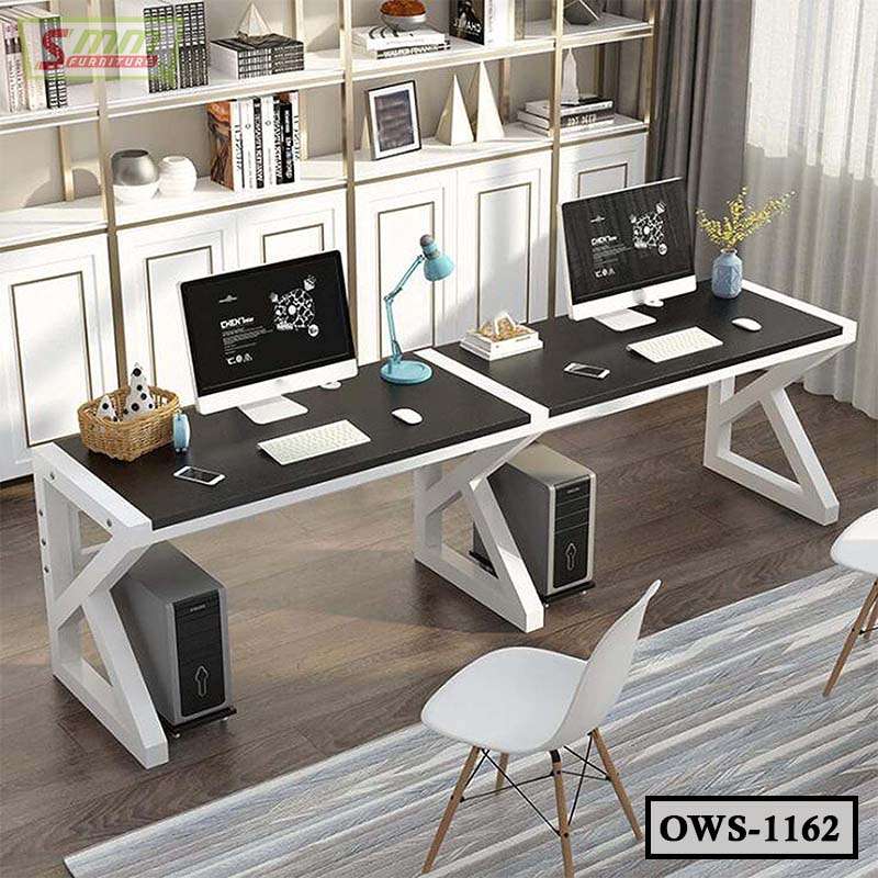 Modern dual office workstation desk with computers, white shelves, and contemporary decor.