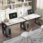 Modern office workstation with dual white desks, computers, black frames, and decorative shelves