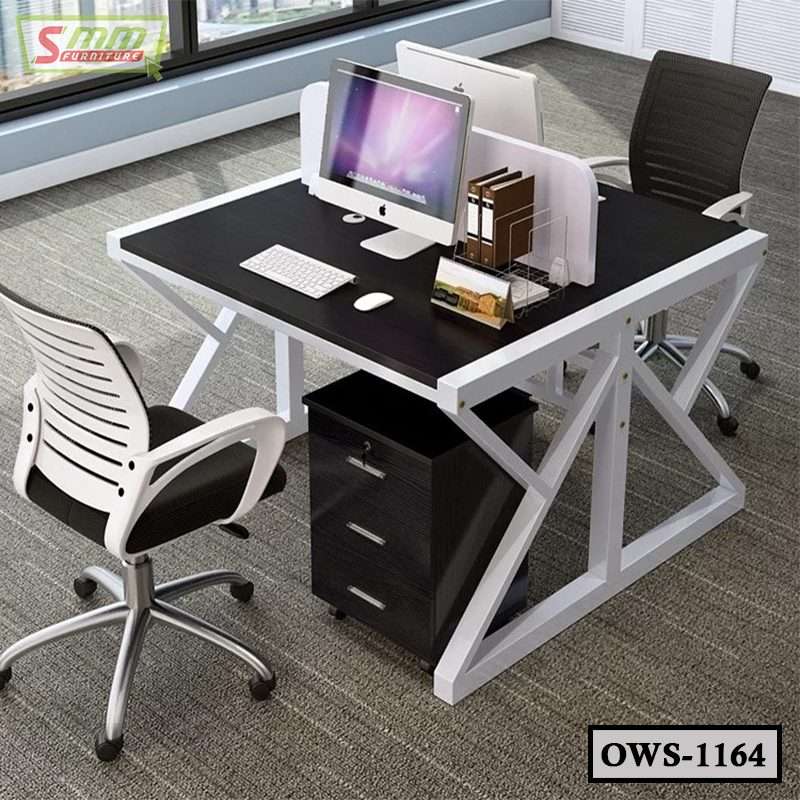 Modern office workstation with two ergonomic chairs, desktop computers, and black and white desk