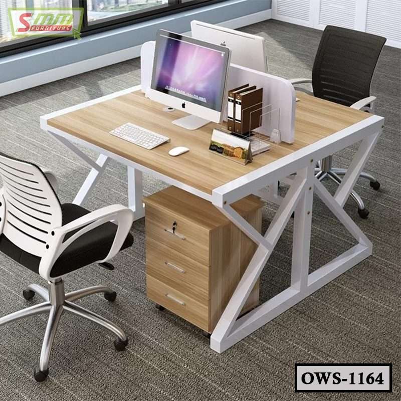 Modern office workstation desk with computers, divider, chairs, and storage drawers