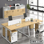 Modern office workstation with four desks, swivel chairs, and storage cabinets in a bright room