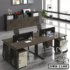 Modern office workstation desk with chairs, divider screens, and storage cabinets in a bright workspace.