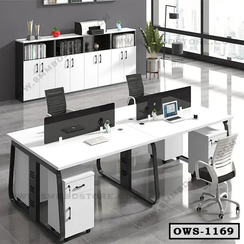Modern office workstation desk with black chairs, storage cabinets, and laptops in a bright workspace