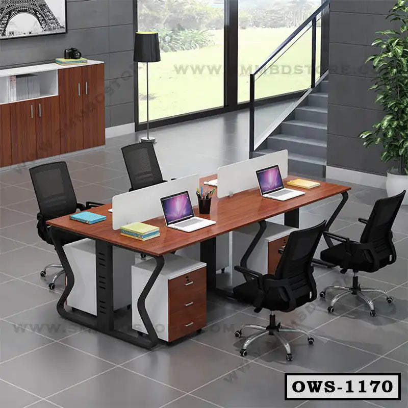 Modern office workstation with four desks, mesh chairs, laptops, and storage drawers