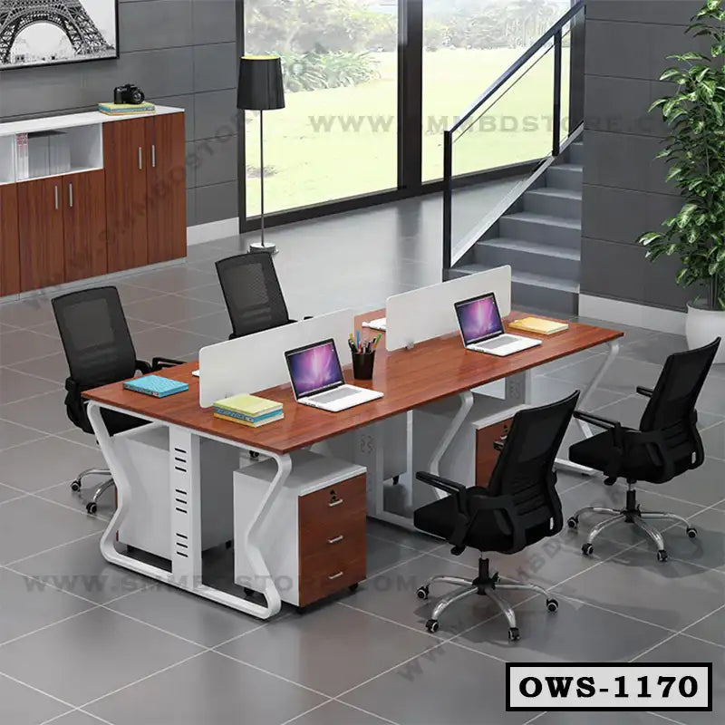 Modern office workstation desk for four with chairs, laptops, and storage cabinets in open workspace