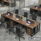 Modern office workstation with wood desks, divider panels, black chairs, and laptops in open workspace