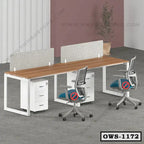 Modern office workstation with wooden tabletop, divider panels, ergonomic chairs, and storage drawers