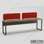 Modern office workstation desk with wood top, black metal frame, and red privacy panels