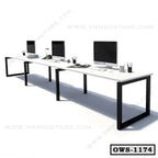 Modern office workstation desk with black metal frame, computers, and desk accessories