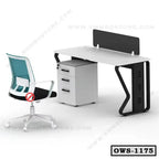 Modern office workstation with a white desk, privacy panel, storage drawers, and ergonomic chair