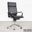 Modern black ergonomic office chair with high backrest, chrome base, and armrests on wheels