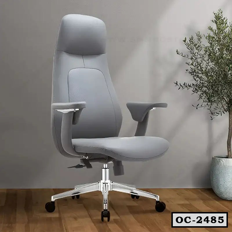 Modern ergonomic grey office chair with adjustable arms on wooden floor, indoor plant nearby