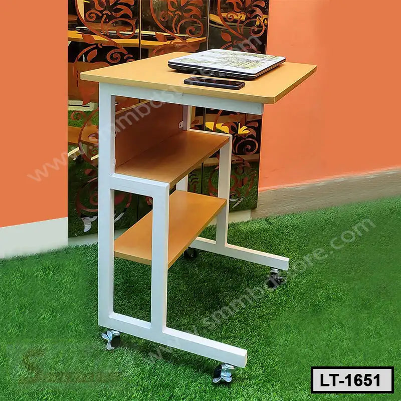 Portable laptop table with wheels, two shelves, and light wood finish, placed indoors